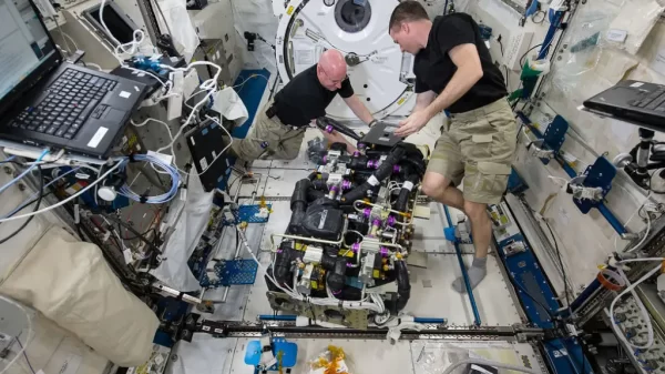 In this image, NASA astronauts Scott Kelly (left) and Terry Virts (right) work on a Carbon Dioxide Removal Assembly (CDRA) inside the station's Japanese Experiment Module. The CDRA system works to remove carbon dioxide from the cabin air, allowing for an environmentally safe crew cabin. Credit: NASA